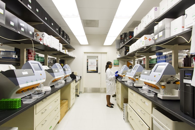 Molecular diagnostics laboratory with real-time PCR instruments and a laboratory technician (illustrative stock photograph)